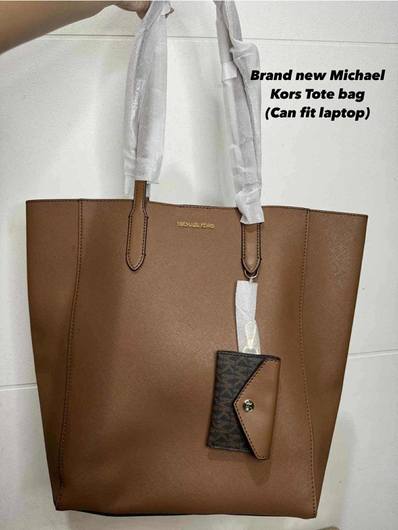 Michael Kors Tote Bag (Category: Luxury Bags & Wallets) located in Cagayan de Oro. Submitted by jajairiv (Listing ID 1396348580, Image 1). Description: - Brand new Michael Kors tote bag - Color: Brown - Includes a small, detachable pouch - Features a shoulder strap - Spacious enough for a laptop - Authentic Michael Kors logo present.