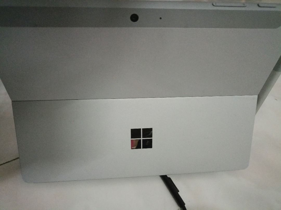 Surface Microsoft Tablet (Category: Windows) located in Kuala Lumpur. Submitted by tenfeet (Listing ID 1396422248, Image 2). Description: - Microsoft Surface tablet - Includes stylus and charger - 4GB RAM - Windows 11 Home - 64-bit operating system - Silver color - Black screen has tiny scratch .