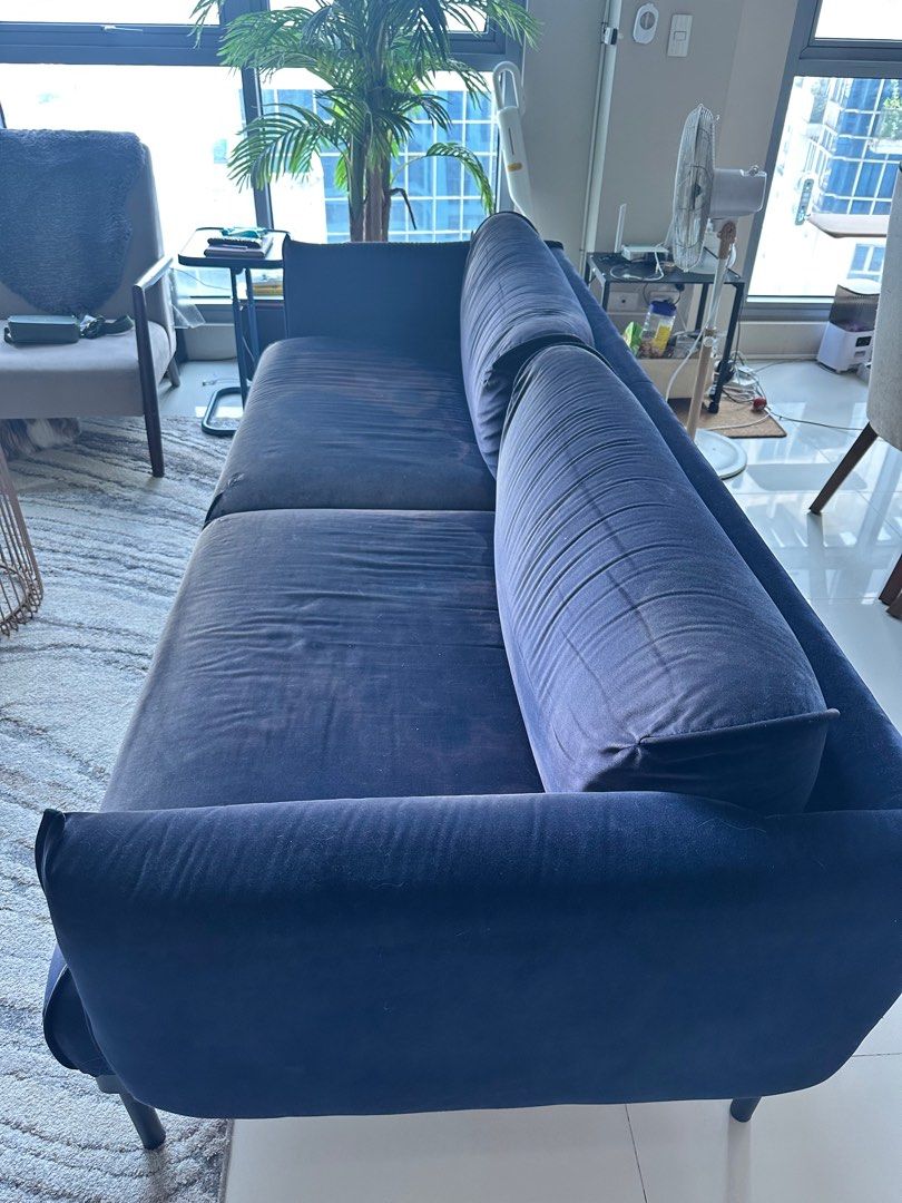 Navy Blue Velvet Sofa (Category: Sofas) located in Manila. Submitted by thriftyfindshub (Listing ID 1396308855, Image 2). Description: - Navy blue velvet sofa - Modern, low-profile design - Sleek black legs - Includes two seat cushions and two bolster pillows - Well-maintained condition.