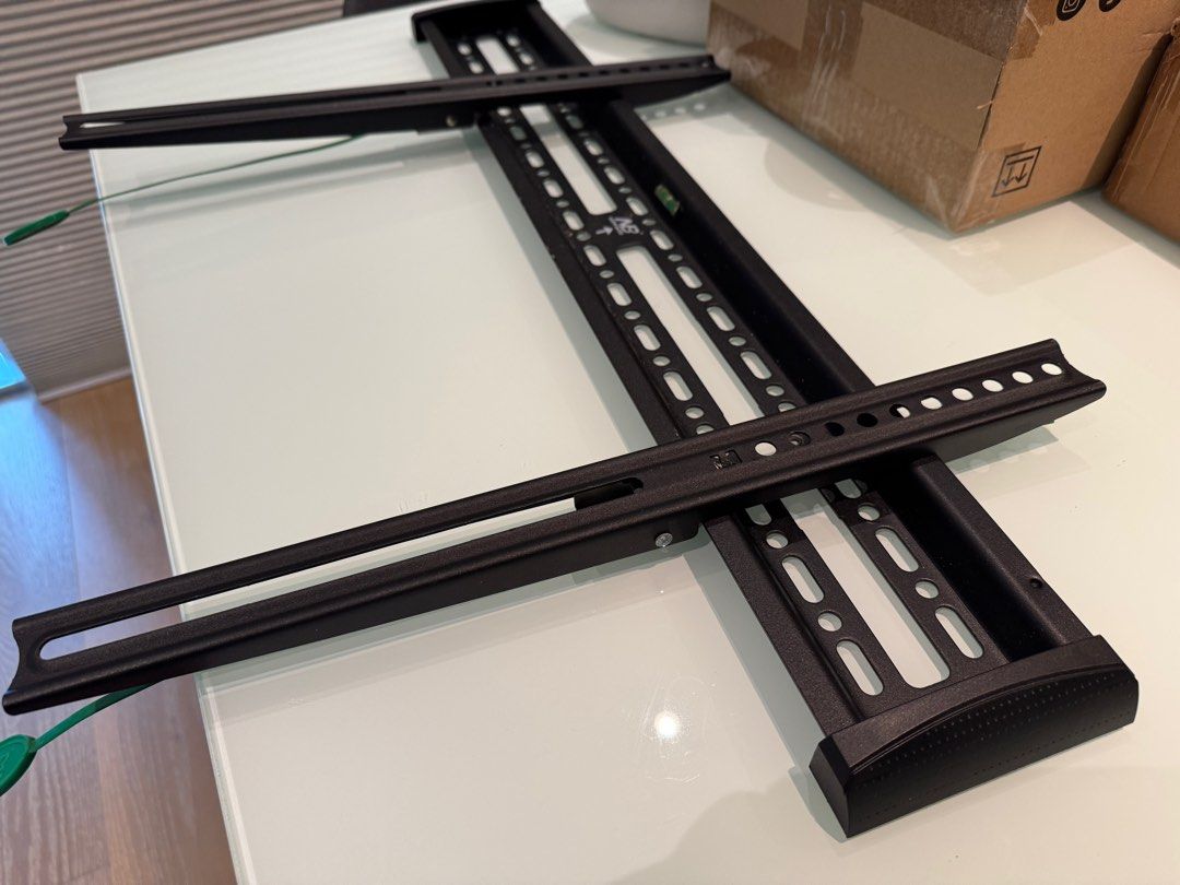 NB Ultra-Thin TV Wall Mount Bracket (Category: TV Parts & Accessories) located in Taguig. Submitted by tepperseller (Listing ID 1396376061, Image 3). Description: Ultra-thin TV wall mount bracket. Supports heavy TVs safely. Includes all necessary components for installation. The main bracket has a built-in level. Compatible with 75/86/98/100 inch TVs. The bracket is black in color. 27.5" long x 4" height .