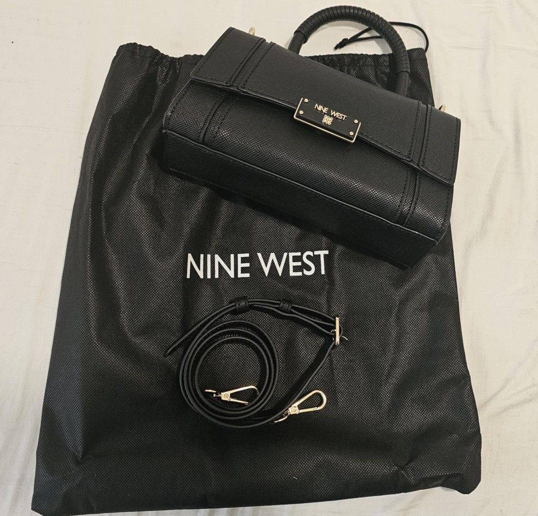 Nine West Black Handbag with Top Handle (Category: Luxury Bags & Wallets) located in Manila. Submitted by bry_d (Listing ID 1396459068, Image 3). Description: - Nine West handbag - Structured design - Top handle and detachable shoulder strap - Rectangular shape with flap closure - Features a small metal logo - Includes dust bag - Gold-toned hardware.