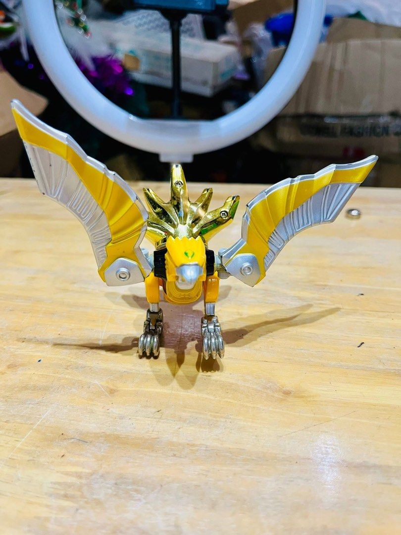 Power Rangers Wild Force - Predazord (Category: Action & Battle Toys) located in Pilar. Submitted by faveanyshop (Listing ID 1396436783, Image 2). Description: - Predazord toy from Power Rangers Wild Force. - Color scheme: Yellow, silver, and gold. - Bird-like design with articulated wings. - Detailed head. - Perfect for Power Rangers collectors..