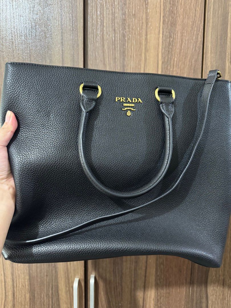PRADA LEATHER TOTE BAG (Category: Luxury Bags & Wallets) located in Quezon City. Submitted by glamfashionboutique (Listing ID 1396340131, Image 1). Description: Prada Tote Bag Leather type Can fit your laptop and be used as work bag, handbag or shoulder ag Comes with long strap and with dustbag Saffiano leather .