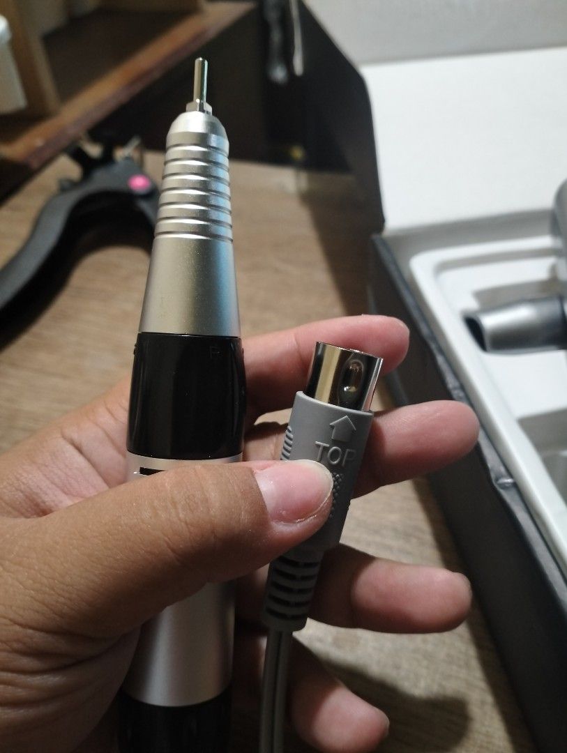 Professional Nail Drill Handpiece (Category: Hands & Nails) located in Paranaque City. Submitted by _andreaaaa13 (Listing ID 1396326043, Image 1). Description: Bought the wrong one and I can't use this. - New, unused nail drill handpiece - Stylish silver and black design - Includes power connector - Ideal for professional nail technicians and personal use Delivery fee will be shouldered by the buyer..