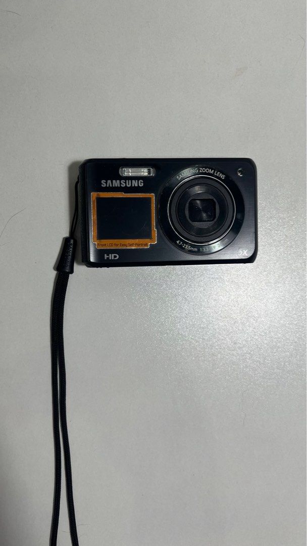 Samsung Digital Camera with 5x Zoom Lens DV100 (Category: Cameras) located in Quezon City. Submitted by hallodu (Listing ID 1396285685, Image 3). Description: - Samsung digital camera - 5x zoom lens - Front LCD screen - Black body - Includes wrist strap - Please see photos for damages - Charging port does not work so you have to charge the battery with an external battery charger - Can give battery charger for free - Zoom in/out button does not w
