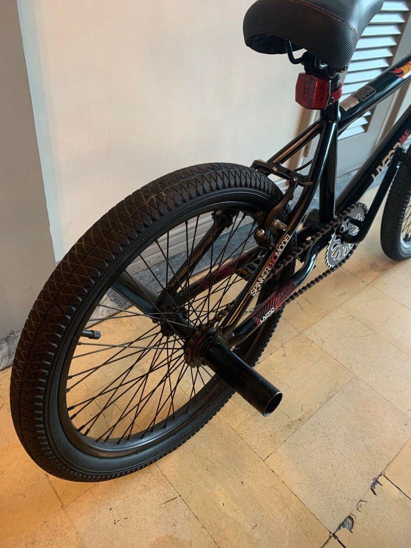 Spinner Hyper 20" BMX Bike (Category: Bicycles) located in Manila. Submitted by mjuanitoch92279 (Listing ID 1396413669, Image 1). Description: - Black Spinner Hyper BMX bike - Black frame, tires, and seat - Features a Hot Wheels logo - Includes chain guard and pegs.