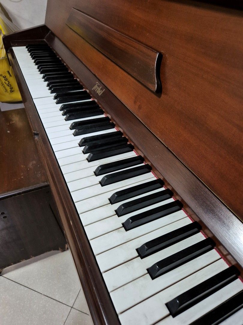 Trebel Piano (Category: Musical Instruments) located in Quezon City. Submitted by pluve.arce06210 (Listing ID 1396289396, Image 3). Description: - Trebel Vertipremium piano - Dark wood finish - Classic design - Black and white keys - Includes matching wooden bench - Trebel logo visible Trebel upright piano May keys na out of tune, di pa napapatono Bought 2007 As is condition, di nagagamit With chair na kasama For pick up only (near Lagro QC) Pric