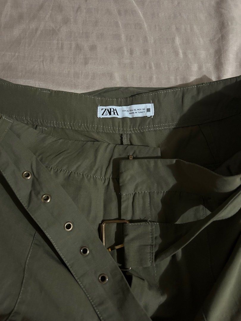 Zara Cargo Pants with Belt (Category: Jeans) located in Makati City. Submitted by declutterwjn_ (Listing ID 1396460101, Image 1). Description: - Zara olive green cargo pants - Includes matching belt with buckle - Relaxed fit - Features pockets and button details - Bought for ₱2k at actual Zara store - Used just once.