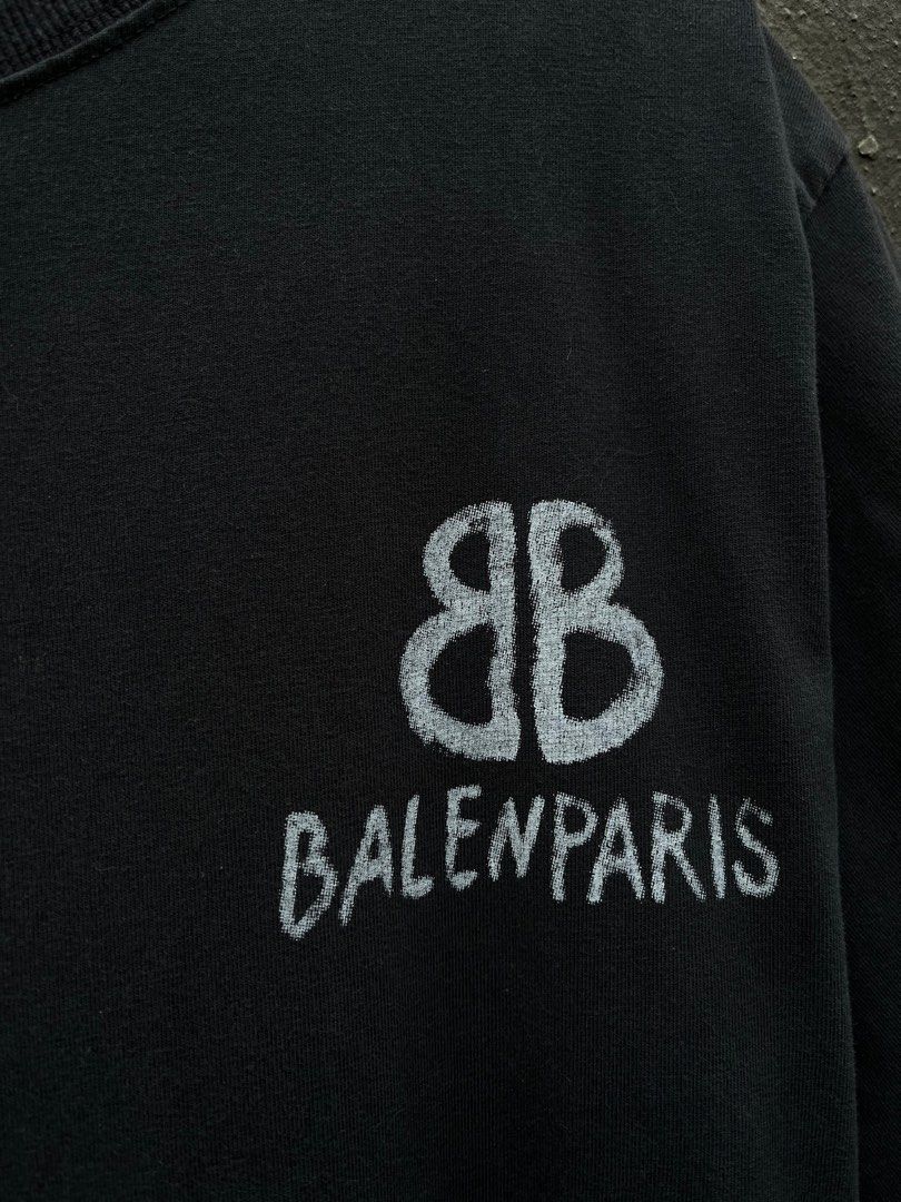 Balenciaga Balenparis Graphic Tee (Category: Tshirts & Polo Shirts ) located in Cebu City. Submitted by thft.lee (Listing ID 1396530654, Image 2). Description: - Balenciaga black t-shirt - Large graphic print on the back - Smaller print on the front - Features Balenciaga logo and "BALENPARIS" - Short sleeves - Crew neck - Made of cotton.