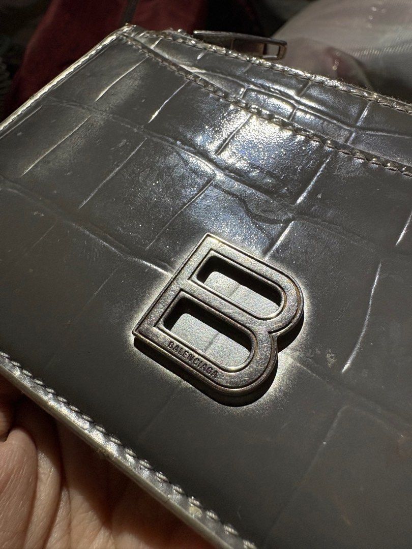 Balenciaga Cardholder (Category: Luxury Bags & Wallets) located in Muntinlupa City. Submitted by _vntglxx (Listing ID 1396600888, Image 3). Description: - Crocodile-embossed design - Zip-around closure - Multiple card slots - Metal 'B' logo - Gray color.