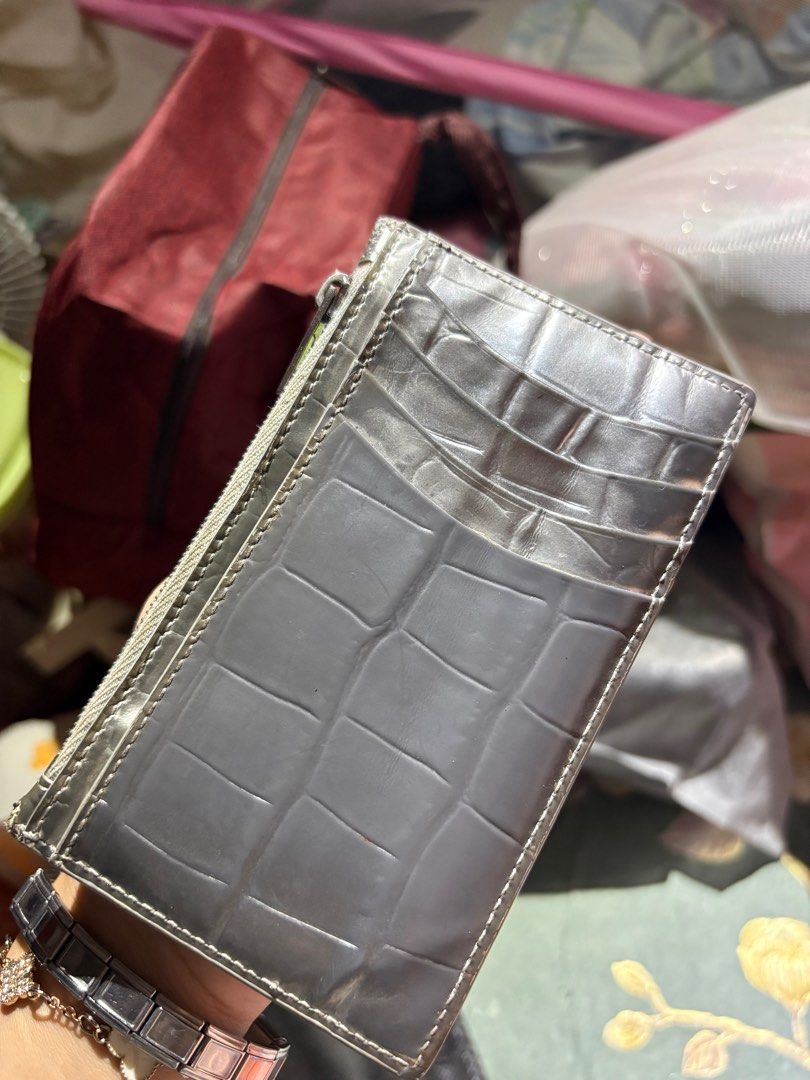 Balenciaga Cardholder (Category: Luxury Bags & Wallets) located in Muntinlupa City. Submitted by _vntglxx (Listing ID 1396600888, Image 2). Description: - Crocodile-embossed design - Zip-around closure - Multiple card slots - Metal 'B' logo - Gray color.