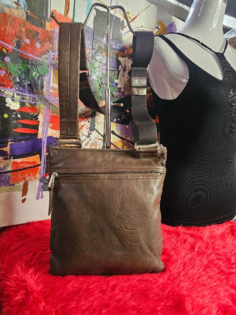 Bally Leather Crossbody Bag (Category: Luxury Bags & Wallets) located in Las Pinas. Submitted by liezel49 (Listing ID 1396632349, Image 2). Description: Authentic Bally shoulder bag in brown leather. Features a zip closure, flap pocket, shoulder strap, and belt loop. Interior has a striped lining. Genuine leather..