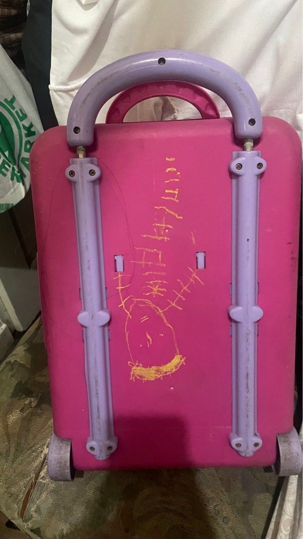 Barbie Doll , Bag and Accessories Set (Category: Kids Toys) located in Quezon City. Submitted by jackpotdecluttering (Listing ID 1396540641, Image 2). Description: - Complete doll set with multiple dolls. - Includes various outfits and accessories. - Comes in a pink carrying case. - Case features a handle and wheels for easy transport. - Accessories include hangers and a bead organizer..