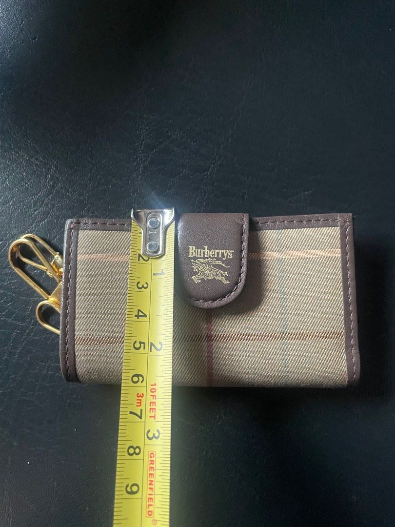 Burberrys Key Holder (Category: Luxury Bags & Wallets) located in Muntinlupa City. Submitted by phbudgetluxuryfinds (Listing ID 1396478891, Image 2). Description: - Authentic Burberry key holder - Classic check pattern - Brown leather flap with Burberrys logo - Multiple gold-toned key hooks - Approximately 10cm long - Secure snap closure.