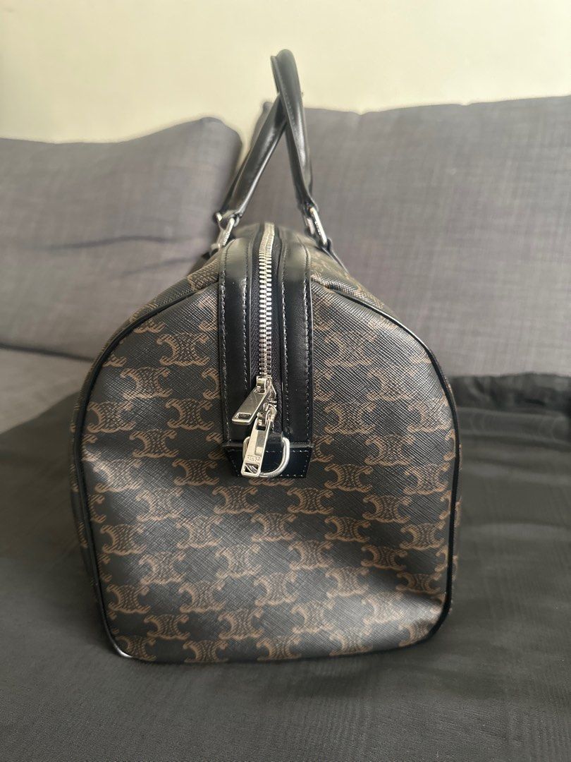 Celine Triomphe Boston Bag (Category: Luxury Bags & Wallets) located in Quezon City. Submitted by luxemen (Listing ID 1396496252, Image 1). Description: - Celine Boston bag - Color: Brown and Black - Features the Triomphe pattern - Includes detachable shoulder strap, dust bag, and care card - Interior lined with light brown fabric - Top zipper closure - Silver-toned hardware.