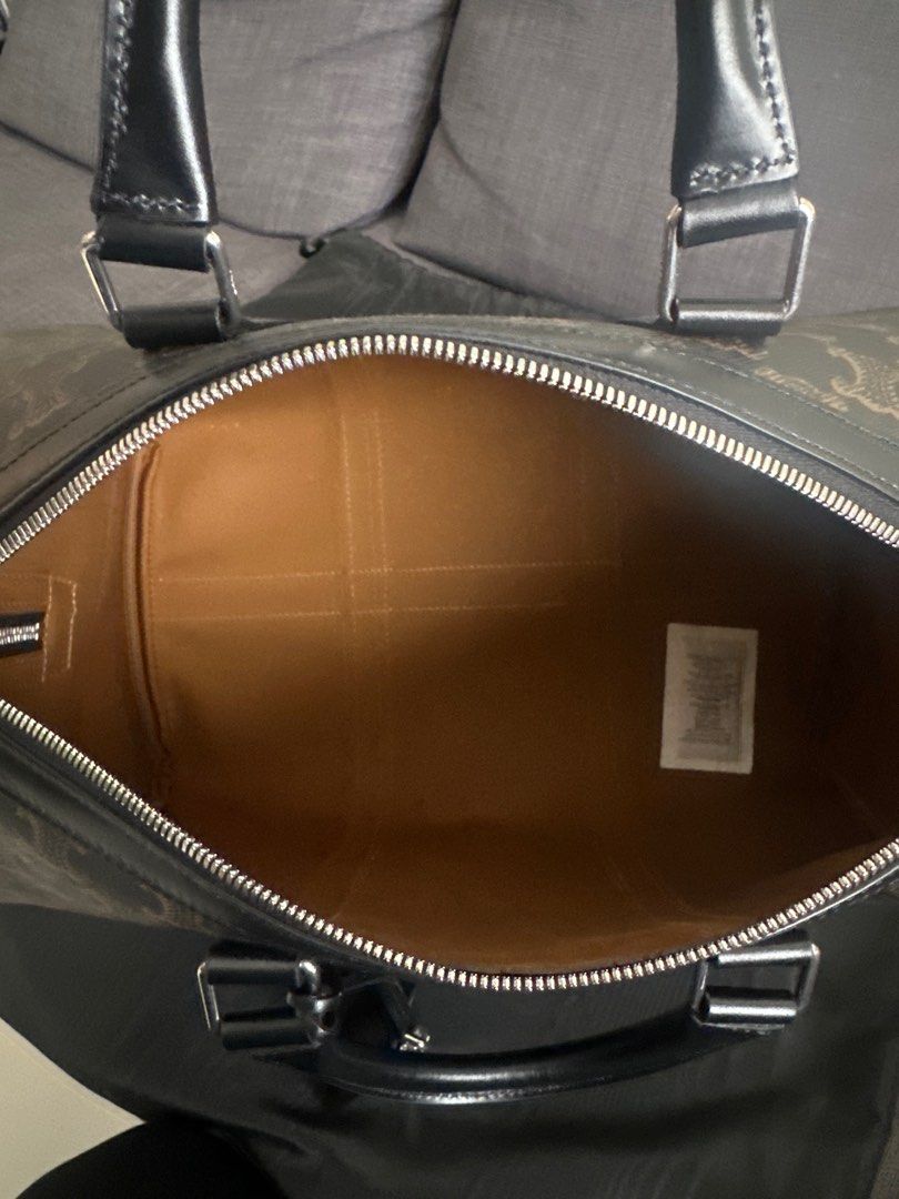 Celine Triomphe Boston Bag (Category: Luxury Bags & Wallets) located in Quezon City. Submitted by luxemen (Listing ID 1396496252, Image 2). Description: - Celine Boston bag - Color: Brown and Black - Features the Triomphe pattern - Includes detachable shoulder strap, dust bag, and care card - Interior lined with light brown fabric - Top zipper closure - Silver-toned hardware.