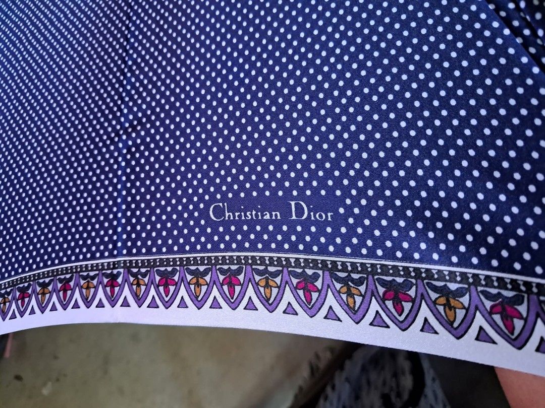 Christian Dior Polka Dot Umbrella (Category: Umbrellas) located in Bayombong. Submitted by thriftymusthave (Listing ID 1396545140, Image 2). Description: - Christian Dior umbrella - Navy blue polka dot design - Black handle with gold accents - Matching polka dot interior - Decorative border - Brand name visible - Stylish and functional accessory Shipping via J& T MoP: Gcash/ BPI .
