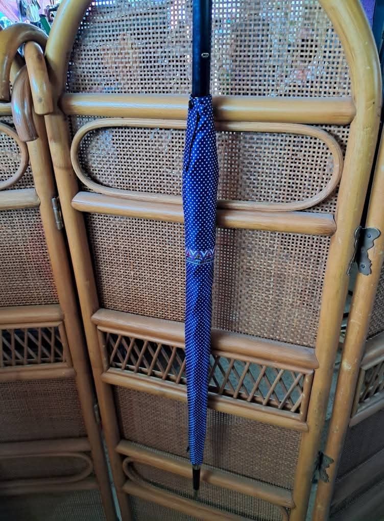 Christian Dior Polka Dot Umbrella (Category: Umbrellas) located in Bayombong. Submitted by thriftymusthave (Listing ID 1396545140, Image 3). Description: - Christian Dior umbrella - Navy blue polka dot design - Black handle with gold accents - Matching polka dot interior - Decorative border - Brand name visible - Stylish and functional accessory Shipping via J& T MoP: Gcash/ BPI .