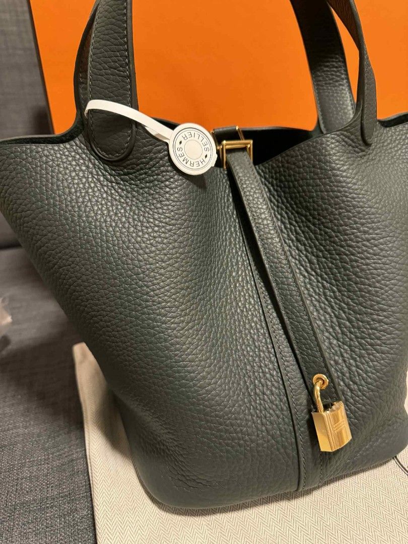 Hermes Picotin 22 Handbag (Category: Luxury Bags & Wallets) located in Bacoor. Submitted by angelguanco (Listing ID 1396493014, Image 2). Description: - Authentic Hermes Picotin 22 - Dark grey color - Includes padlock closure - Complete inclusions with receipts - Comes with original box and dust bag - Classic tote design - Structured shape.