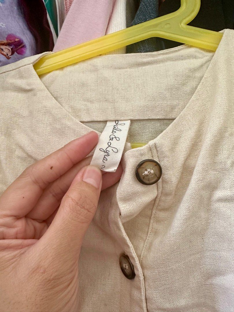 Laila & Lyra Romper (Category: Babies & Kids Fashion) located in Cavite. Submitted by Ersdecluts (Listing ID 1396527699, Image 2). Description: - Bella & Lyra cream-colored romper - Short sleeves - Button-down front - Two front pockets - Simple, classic design - Light-colored fabric.