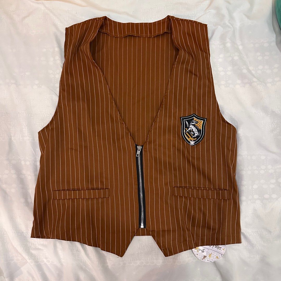 Romwe Harry Potter Hufflepuff Vest - Size L (Category: Vests) located in Cainta. Submitted by moshiiicake (Listing ID 1396606693, Image 1). Description: - Brand: Romwe - Style: Harry Potter Hufflepuff Vest - Size: L - Design: Brown and white striped - Features: Hufflepuff crest, zip closure, two front pockets - Condition: Officially licensed product.