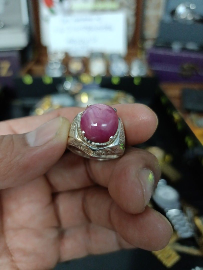 Ruby Gemstone Ring (Category: Accessories) located in Kota Bharu. Submitted by dzihnin8333 (Listing ID 1396657003, Image 2). Description: - Oval-shaped ruby gemstone - Set in a silver band - Intricate band detailing - Vibrant pinkish-red hue - Statement ring.