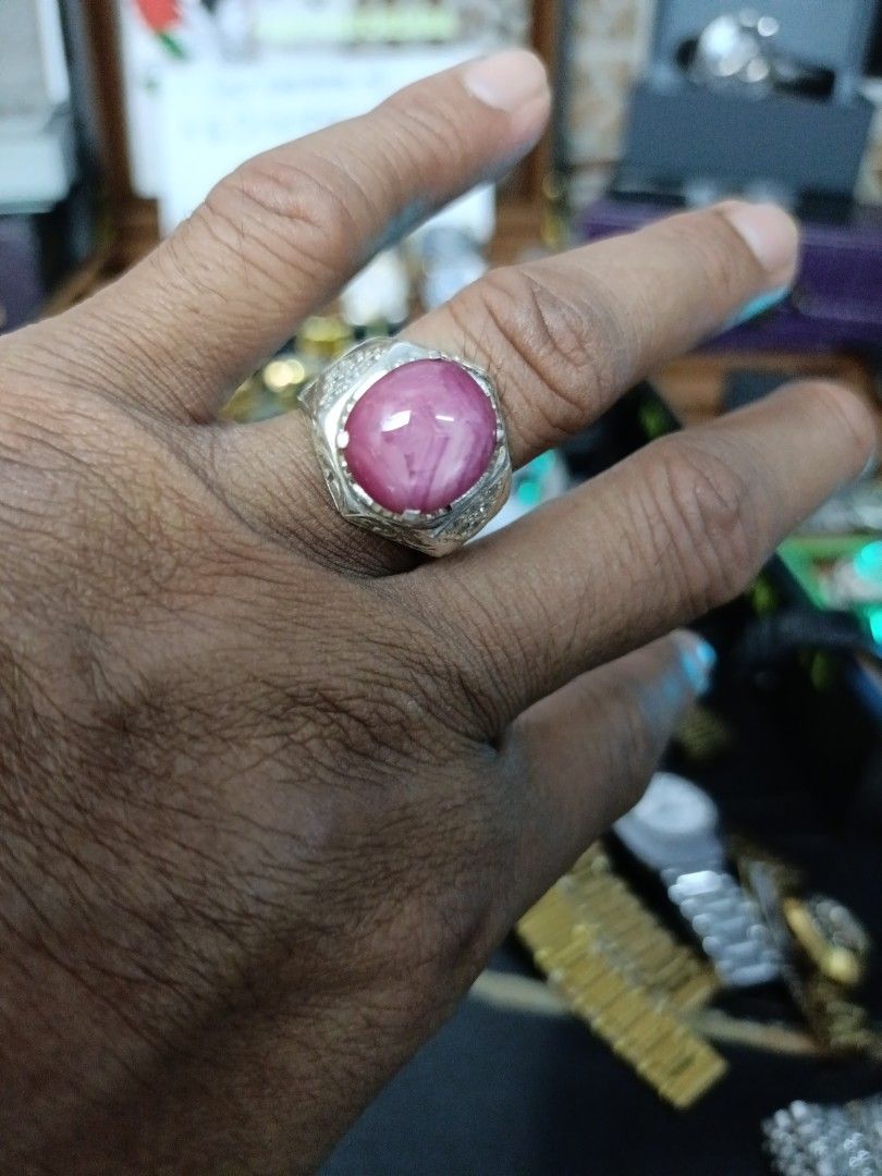 Ruby Gemstone Ring (Category: Accessories) located in Kota Bharu. Submitted by dzihnin8333 (Listing ID 1396657003, Image 3). Description: - Oval-shaped ruby gemstone - Set in a silver band - Intricate band detailing - Vibrant pinkish-red hue - Statement ring.