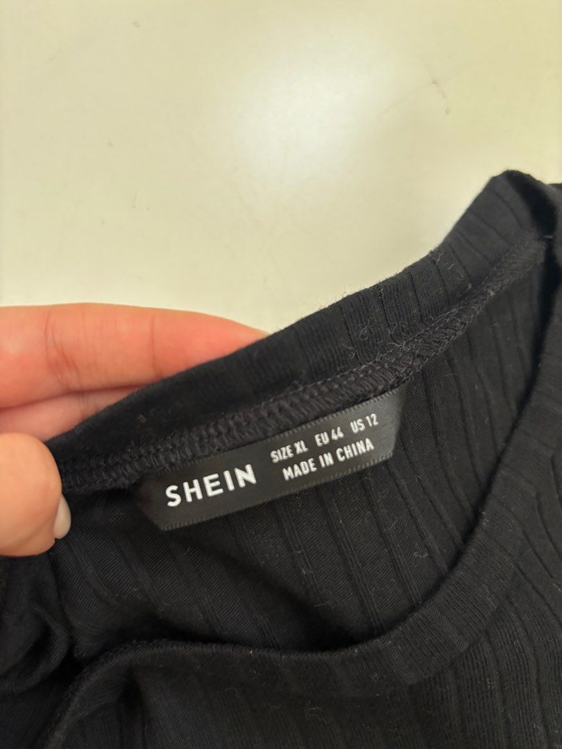 Shein Black Ribbed Crop Top (Category: Shirts) located in Rodriguez. Submitted by alekshivers (Listing ID 1396534800, Image 2). Description: - Shein black ribbed crop top - Size: Small to Medium - Features: Round neckline, short sleeves, ruffled hem - Made in China.