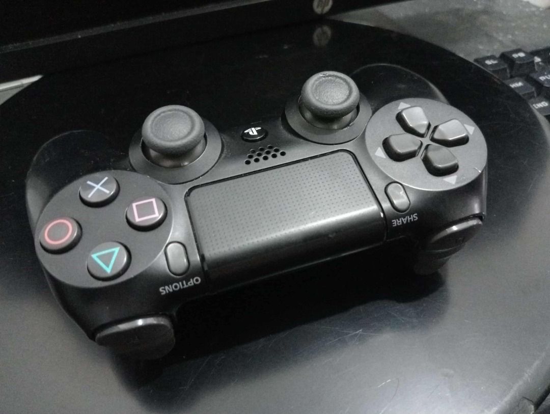 Sony PlayStation 4 Controller (Category: Controllers) located in Quezon City. Submitted by potfishcake (Listing ID 1396522233, Image 1). Description: - Black Sony PlayStation 4 controller - Standard button layout - Features touchpad, directional pad, and dual analog sticks - Includes PlayStation button and share/options buttons - Designed for use with the PlayStation 4 console.