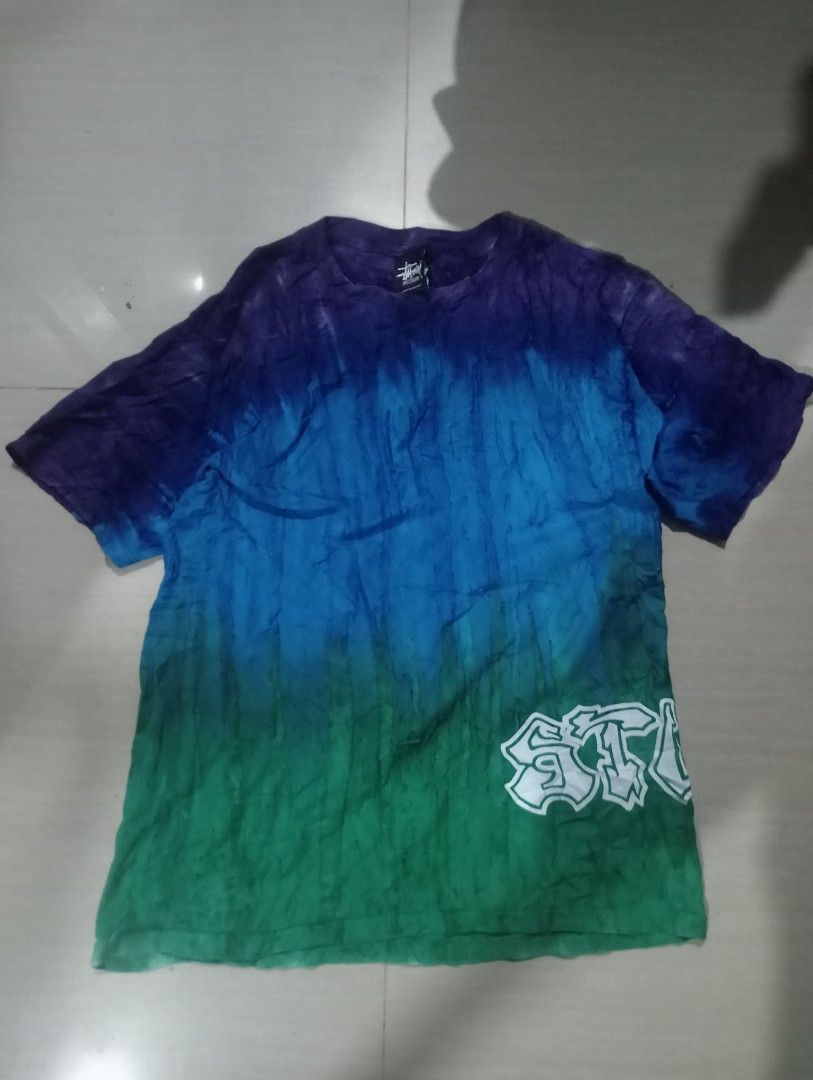 Stussy Tie-Dye T-Shirt - Medium (Category: Tshirts & Polo Shirts ) located in Bolinao. Submitted by willaskyle19427 (Listing ID 1396610244, Image 2). Description: - Authentic Stussy tie-dye t-shirt - Size: Medium - Unique gradient design (purple, blue, green) - Features the Stussy logo - Made in Mexico - Material: 100% cotton - Care label included.