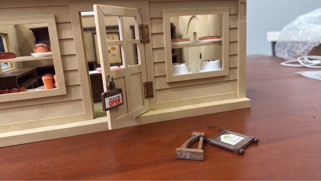 Sylvanian Families Bakery Boulangerie Playset (Category: Kids Toys) located in General Trias. Submitted by brightdog-224c (Listing ID 1396492637, Image 2). Description: - Sylvanian Families Bakery playset - Includes bakery building - Features shelves and counter - Comes with miniature cakes, bread, and donuts - Includes 'Open' sign and menu board - Comes with original box - Red roof and detailed interior.