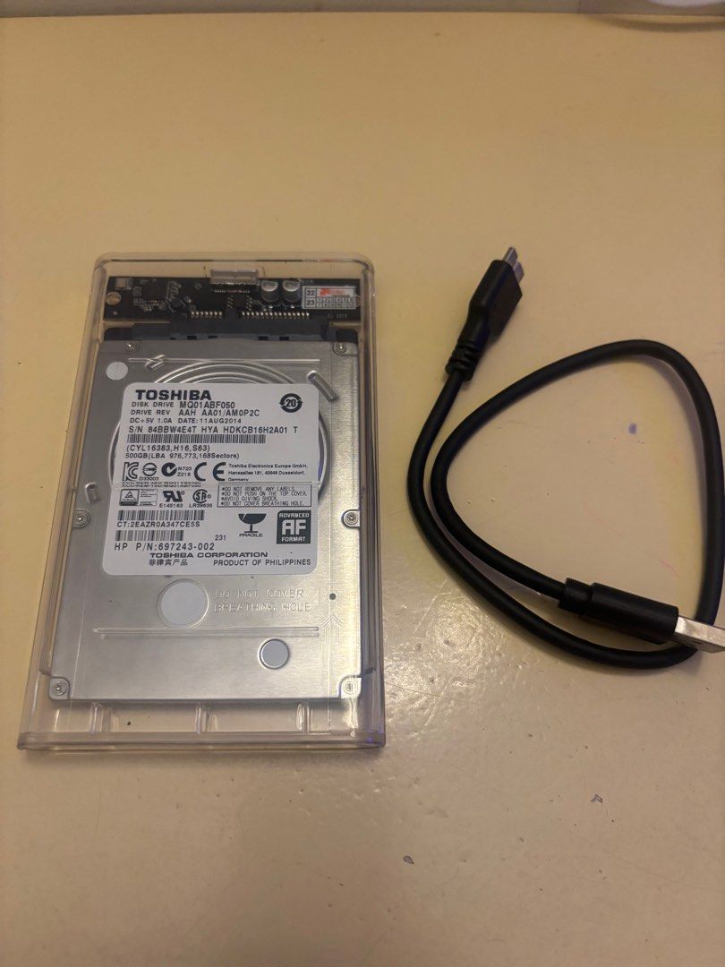 Toshiba External Hard Drive 500gb (Category: Hard Disks & Thumbdrives) located in Antipolo. Submitted by nokiestar2013 (Listing ID 1396578230, Image 2). Description: - Toshiba external hard drive - Includes protective case - Comes with USB cable - Model number: AA01 AM0P2C - Serial number: 84BBW64T - Portable storage solution.