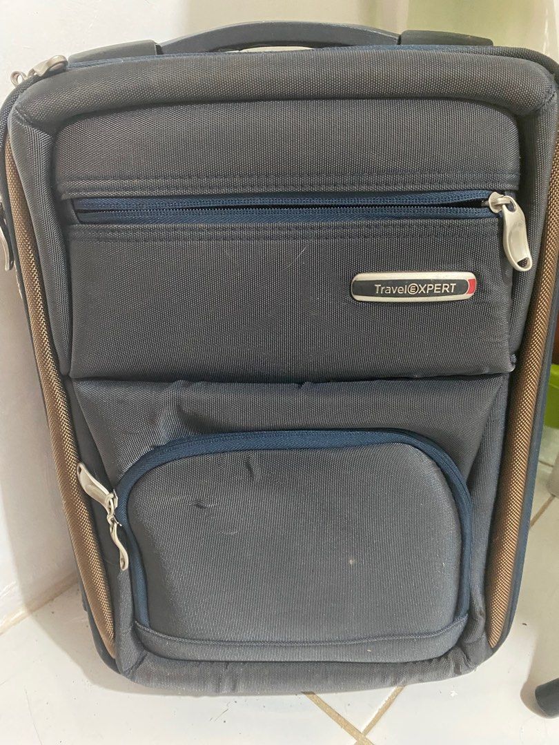Travel Xpert Luggage (Category: Luggage) located in General Tinio. Submitted by andy_1129 (Listing ID 1396478279, Image 2). Description: - Travel Xpert Luggage - Color: Dark Grey with Brown Accents - Features: - Multiple Compartments - Zippered Closure - Top Handle - Wheels for Easy Transport - Front Pocket - Side Zipper - Interior Straps to Secure Belongings - Interior Mesh Pocket.