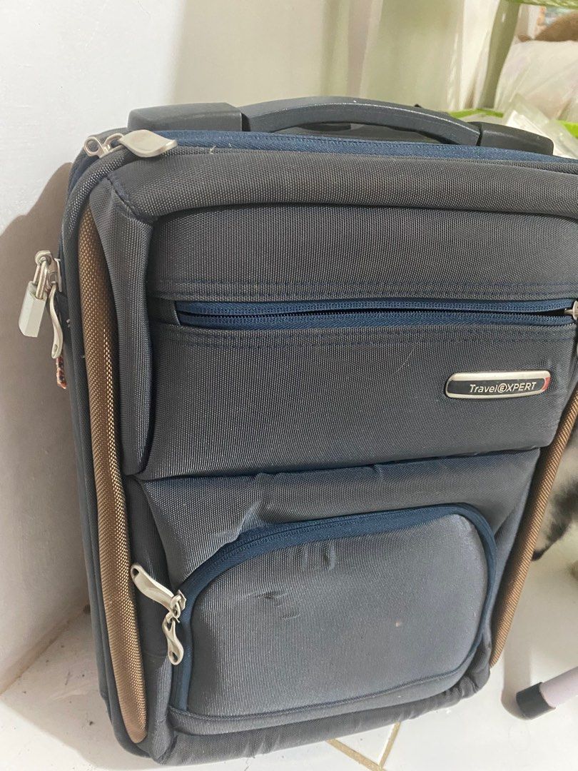 Travel Xpert Luggage (Category: Luggage) located in General Tinio. Submitted by andy_1129 (Listing ID 1396478279, Image 3). Description: - Travel Xpert Luggage - Color: Dark Grey with Brown Accents - Features: - Multiple Compartments - Zippered Closure - Top Handle - Wheels for Easy Transport - Front Pocket - Side Zipper - Interior Straps to Secure Belongings - Interior Mesh Pocket.