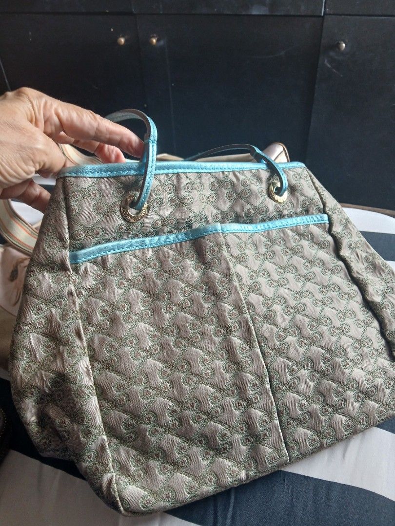 Anya Drawstring Handbag (Category: Luxury Bags & Wallets) located in Quezon City. Submitted by chlokay (Listing ID 1396721806, Image 1). Description: Anya drawstring handbag with a unique pattern. Features light blue trim and handles, a light brown exterior and interior lining with a repeating pattern, and a zipper pocket. Drawstring closure..