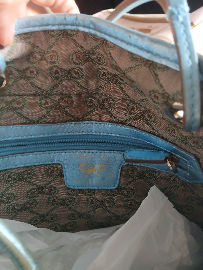 Anya Drawstring Handbag (Category: Luxury Bags & Wallets) located in Quezon City. Submitted by chlokay (Listing ID 1396721806, Image 2). Description: Anya drawstring handbag with a unique pattern. Features light blue trim and handles, a light brown exterior and interior lining with a repeating pattern, and a zipper pocket. Drawstring closure..