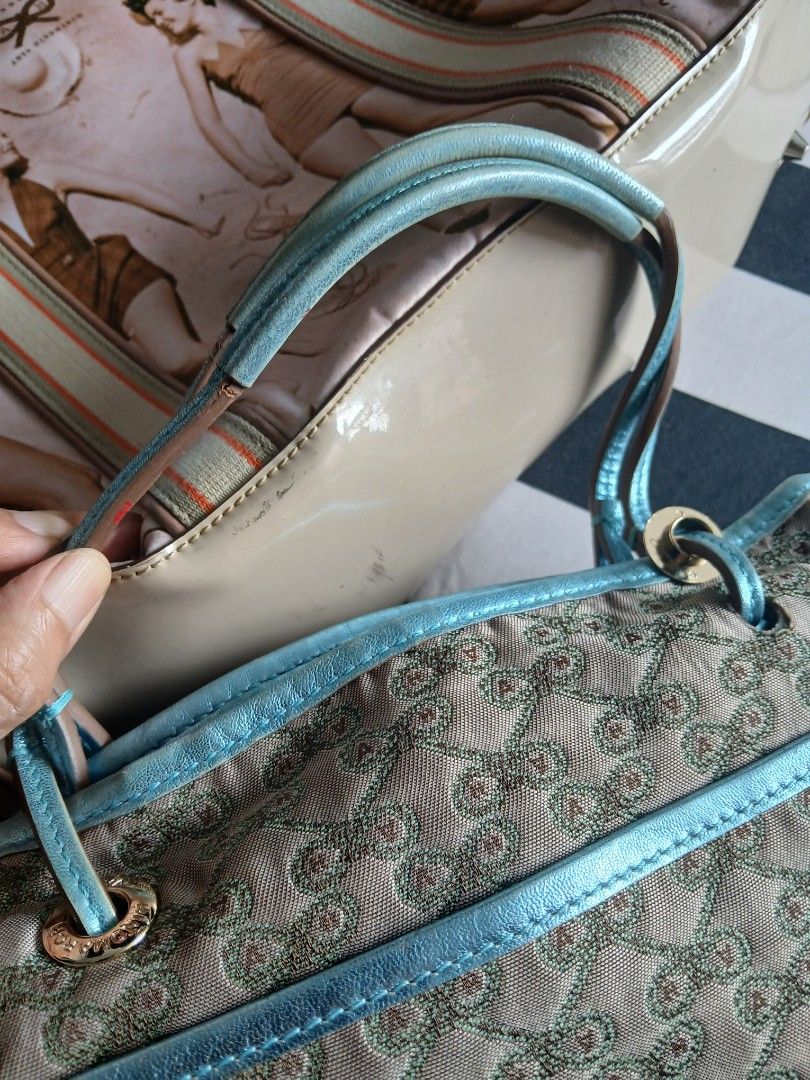 Anya Drawstring Handbag (Category: Luxury Bags & Wallets) located in Quezon City. Submitted by chlokay (Listing ID 1396721806, Image 3). Description: Anya drawstring handbag with a unique pattern. Features light blue trim and handles, a light brown exterior and interior lining with a repeating pattern, and a zipper pocket. Drawstring closure..