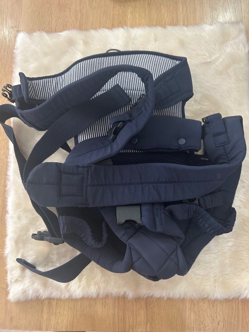 Baby Carrier - Navy Blue (Category: Carriers & Slings) located in Calamba. Submitted by decluttering_momma_ (Listing ID 1396833338, Image 1). Description: - Navy blue baby carrier - Striped lining - Adjustable straps and buckles for a secure fit - Well-padded for baby's comfort - Mesh back panel for breathability - Designed for comfortable baby carrying.