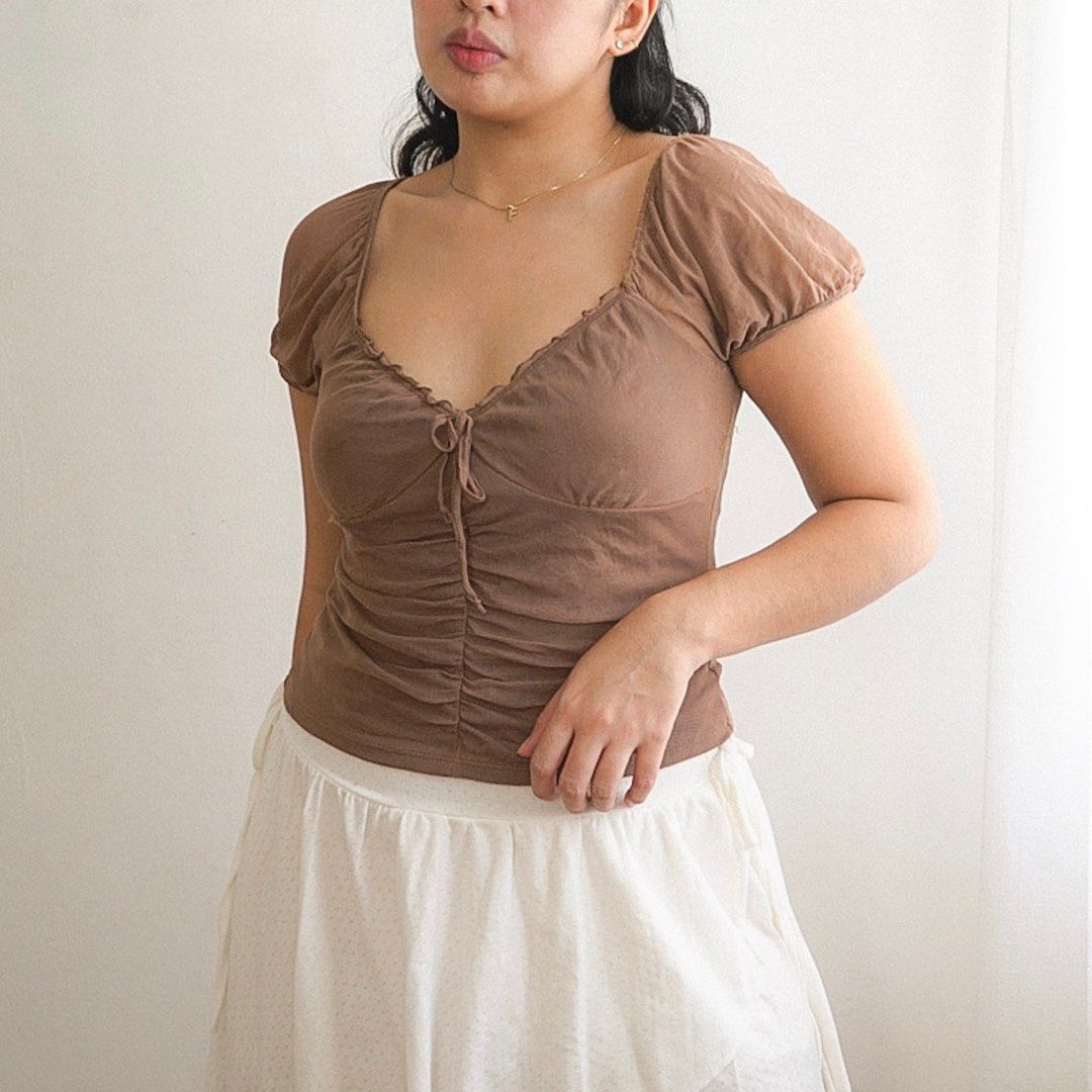 Brown Sheer Milkmaid Ruched Two-way Mesh Top (Category: Blouses) located in Manila. Submitted by fayealmo (Listing ID 1396734054, Image 2). Description: - in good condition, no flaws - Brown off-shoulder top - Sweetheart neckline - Tie detail at bust - Ruched front detailing - Short sleeves - Made of soft, lightweight fabric - Dress up or down.