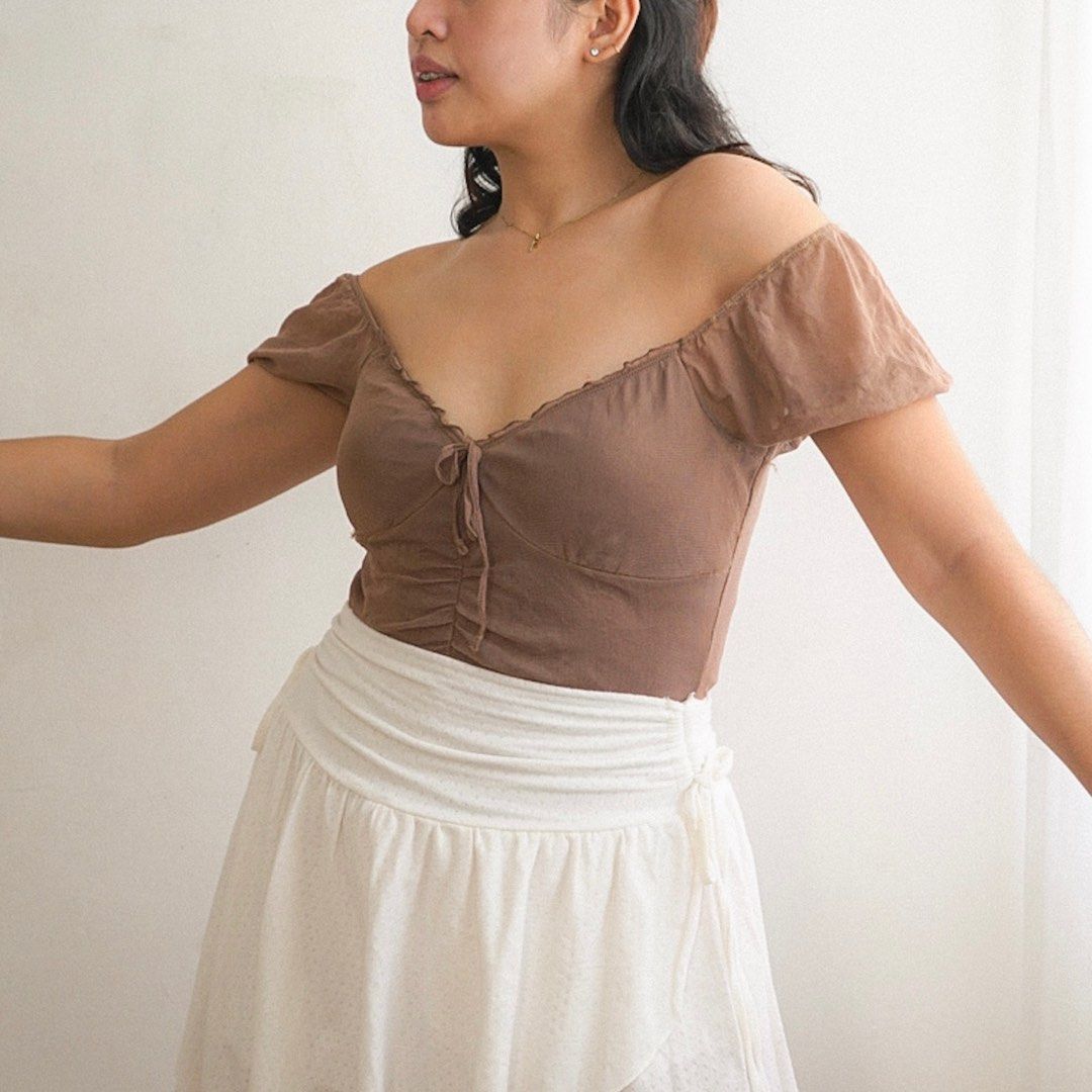 Brown Sheer Milkmaid Ruched Two-way Mesh Top (Category: Blouses) located in Manila. Submitted by fayealmo (Listing ID 1396734054, Image 1). Description: - in good condition, no flaws - Brown off-shoulder top - Sweetheart neckline - Tie detail at bust - Ruched front detailing - Short sleeves - Made of soft, lightweight fabric - Dress up or down.