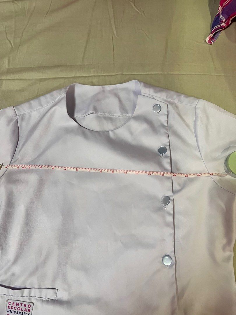 Centro Escolar University Uniform Set (Category: Sets or Coordinates) located in Manila. Submitted by declutterrrrrrrph (Listing ID 1396788870, Image 1). Description: - CEU white uniform set - Includes top and light blue pants - Top features: - Unique button design - Pocket with CEU logo - Short sleeves - Measurements available in photos.