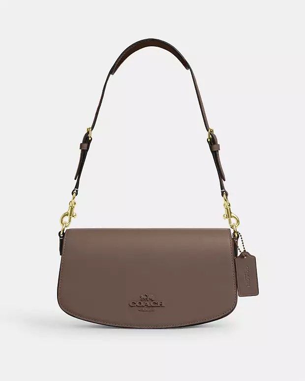 Coach Andrea Shoulder Bag (Category: Luxury Bags & Wallets) located in Orani. Submitted by xtine_rose (Listing ID 1396809237, Image 1). Description: - Coach Andrea shoulder bag - DarkStone color - Flap closure with magnetic snap - Detachable shoulder strap - Small interior pocket - Coach logo on front - Includes hang tag - Suede-like interior lining.