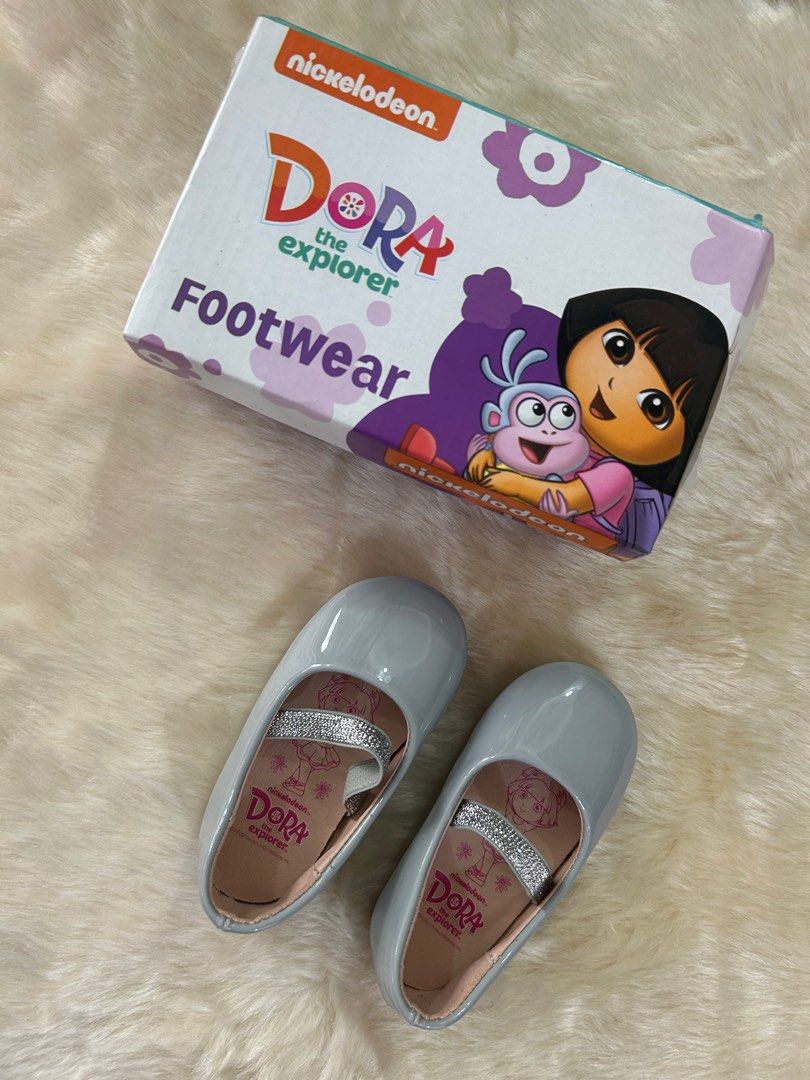 Dora the Explorer Footwear - Grey - Size 20 (Category: Babies & Kids Fashion) located in Calamba. Submitted by decluttering_momma_ (Listing ID 1396833646, Image 1). Description: - Dora the Explorer shoes - Color: Grey - Size: 20 - Features a glitter strap - Dora the Explorer design on insole - Comes with original box Used once only during her 1st bday celebration.