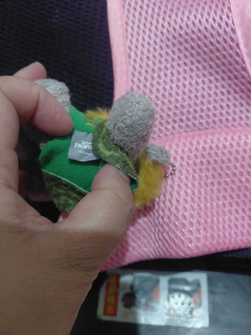Frozen Troll Plush Keychain (Category: Plushies & Soft Toys) located in Manila. Submitted by bashamylove0116 (Listing ID 1396768652, Image 3). Description: - Frozen Troll plush keychain - Features a grey character - Accented with yellow and green - Character is wearing a green patterned outfit - Includes a metal chain - Small, collectible item.