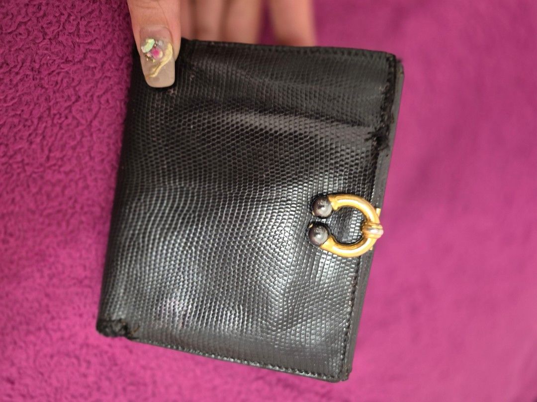 Gucci Black Leather Wallet (Category: Luxury Bags & Wallets) located in Angeles City. Submitted by clie15 (Listing ID 1396710614, Image 1). Description: - Authentic Gucci wallet - Black leather exterior - Gold-tone clasp with Gucci logo - Multiple card slots and compartments - Textured finish - Clasp features two dark spherical accents.