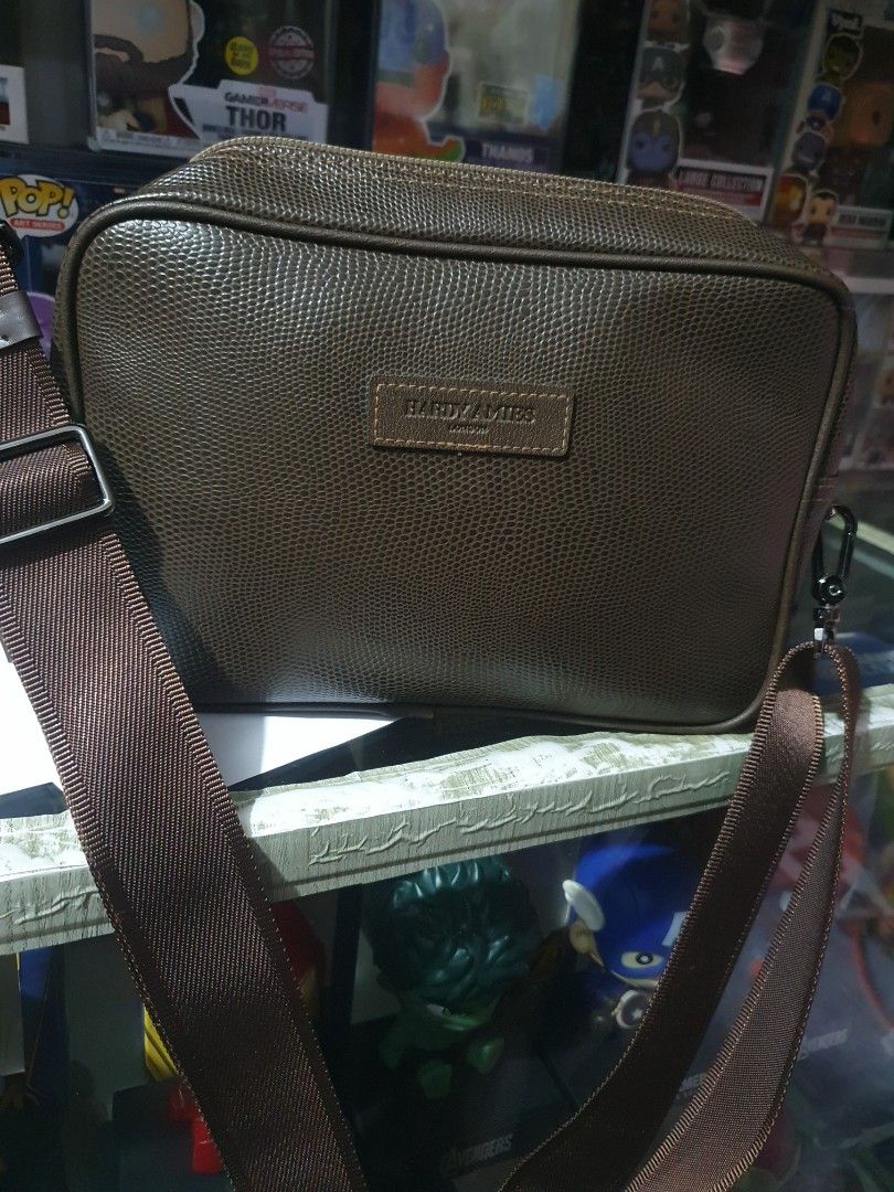 Hardy Amies Crossbody Bag (Category: Luxury Bags & Wallets) located in Quezon City. Submitted by pongoy (Listing ID 1396720370, Image 2). Description: - Brand: Hardy Amies - Style: Crossbody bag - Features: Textured finish, adjustable strap, zip closure - Design: Rectangular shape, classic design - Perfect for everyday use.