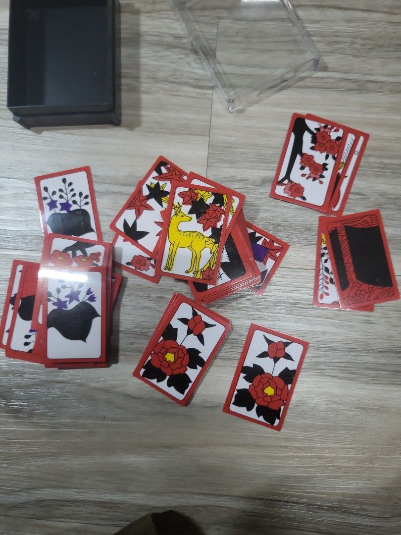Japanese Hanafuda Playing Cards (Category: Board Games & Puzzles) located in Caloocan City. Submitted by lynette1977 (Listing ID 1396820171, Image 1). Description: - Authentic Japanese Hanafuda playing cards - Features beautiful floral and animal illustrations - Comes with a clear plastic storage case - Cards have red borders - Rectangular card shape.