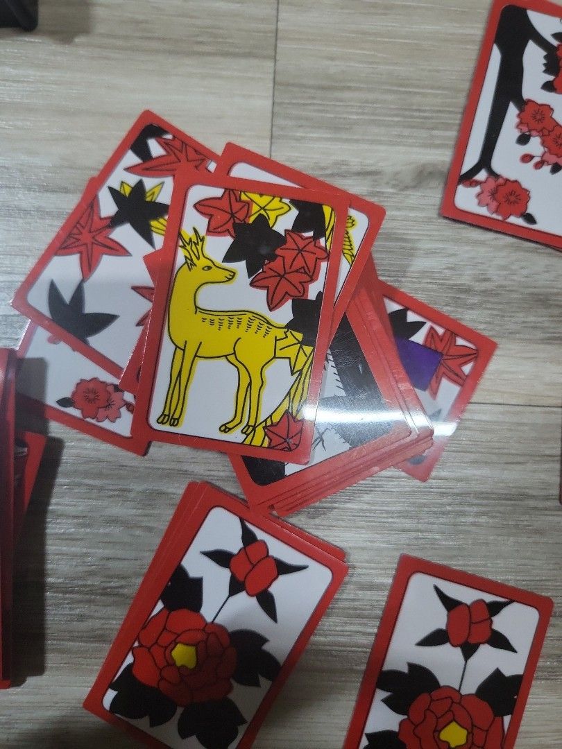 Japanese Hanafuda Playing Cards (Category: Board Games & Puzzles) located in Caloocan City. Submitted by lynette1977 (Listing ID 1396820171, Image 3). Description: - Authentic Japanese Hanafuda playing cards - Features beautiful floral and animal illustrations - Comes with a clear plastic storage case - Cards have red borders - Rectangular card shape.