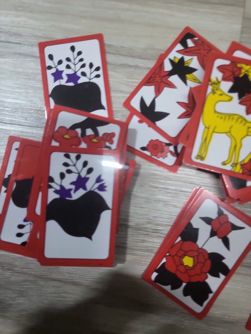 Japanese Hanafuda Playing Cards (Category: Board Games & Puzzles) located in Caloocan City. Submitted by lynette1977 (Listing ID 1396820171, Image 2). Description: - Authentic Japanese Hanafuda playing cards - Features beautiful floral and animal illustrations - Comes with a clear plastic storage case - Cards have red borders - Rectangular card shape.