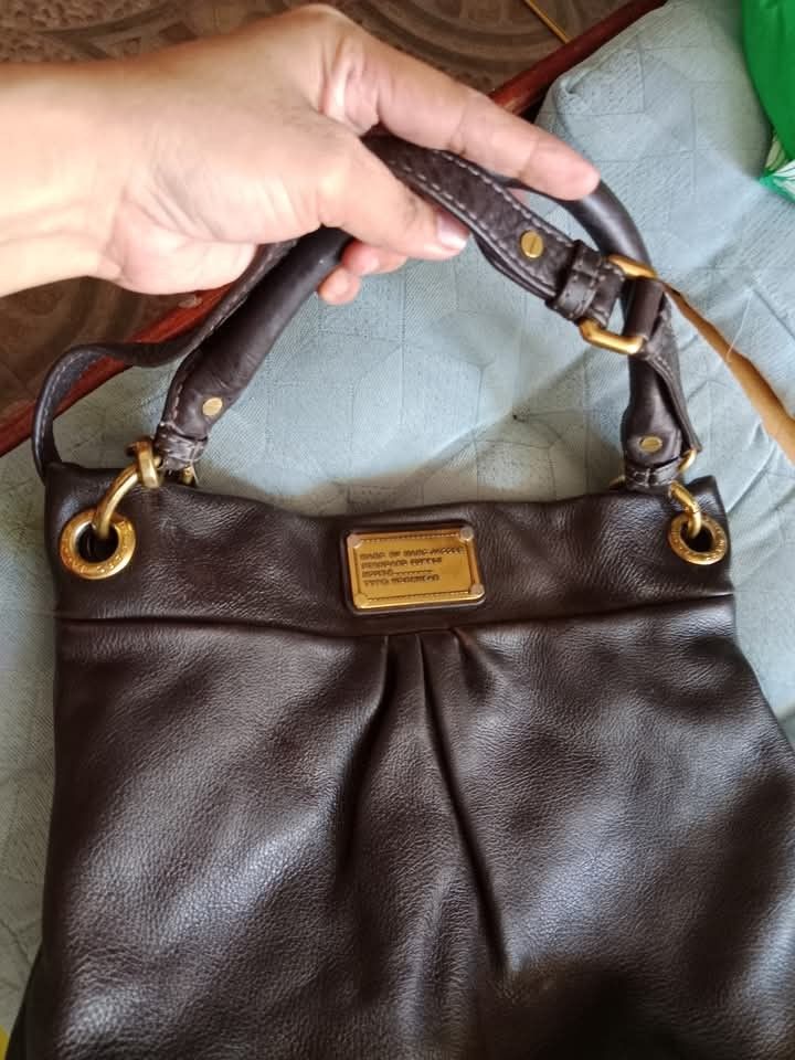 MarcJacobs brown (Category: Luxury Bags & Wallets) located in Angeles City. Submitted by mjshoppingretail (Listing ID 1396704433, Image 2). Description: - Authentic Marc by Marc Jacobs hobo bag - Brown leather - Classic design - Top handle and shoulder strap - Gold-tone hardware - Signature logo plate - High-quality leather - Stylish and functional.